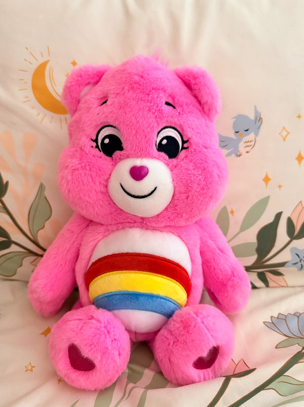 Pink care bear with a rainbow belly 